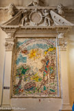 <center>Cathédrale Notre-Dame de la Nativité</center>Chagall a voulu exprimer la joie du baptême en prenant pour thème Moïse sauvé des eaux. Et c’est bien la joie qui rayonne de sa mosaïque, avec ses couleurs claires et variées, les fleurs ou les fruits des arbres de la rive, les robes bigarrées des femmes, l’éclat du soleil et ses reflets sur les eaux. Cette joie s’adoucit et s’épure dans le regard de la fille du Pharaon et la tendresse du geste, quand elle se penche vers le petit Moïse pour le recevoir. La joie de la mosaïque n’est pas une joie terrestre : elle transpose l’épisode rapporté dans l’Exode pour l’élever jusqu’à la joie spirituelle du baptême. La fille du Pharaon qui recueille le petit Moïse devient l’Eglise recevant un nouveau-né ; et celui-ci, par l’eau du baptême évoquée par l’eau du Nil, devient un enfant de Dieu. C’est bien ainsi qu’il faut lire la mosaïque puisque Marc Chagall a introduit dans sa composition des éléments insolites pour l’illustration du texte biblique : un Ange, auprès du soleil et, surtout, l’arc dans le ciel. Ce pont céleste est le signe traditionnel de l’alliance de Dieu à son peuple. Au baptistère de Vence, Moïse sauvé des eaux est vraiment la préfiguration spirituelle du sacrement.