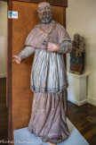 <center>Conflans : Musée d’Art et d’Histoire.</center> Saint-François-de-Sales (1567 – 1622).
Bois polychrome. XVIIe siècle. Pays de Savoie.
Né en 1567 au château de Sales à Thorens Glières (Haute-Savoie), il est d'abord missionnaire dans le Chablais « pour ramener à la foi catholique cette région gagnée au calvinisme » avant d'accéder en 1602 au siège épiscopal de Genève et de fonder l'ordre de la Visitation. Grand théologien et grand prêcheur, il exerce une influence toute particulière en cette période de réforme non seulement au sein de l’Église catholique, mais aussi des souverains tant français que savoyards. De son vivant, il jouit d'une réputation de sainteté et de nombreux malades viennent le voir dans l'espoir d'une guérison. Les femmes enceintes le prient dans l'espoir d'un accouchement sans douleur. Sa canonisation, dès 1665, amplifie son rôle d'intercesseur et son tombeau devient un lieu de pèlerinage important. En 1681 une chapelle dédiée à saint François de Sales est érigée dans l'église de Conflans. Et ce sont toutes les églises de Savoie qui honoreront à l'aide de statue ou de peinture, celui que l'on pourrait appeler le « héros savoyard » de la réforme. Écrivain, il laisse une œuvre importante : Introduction à la vie dévote, etc.