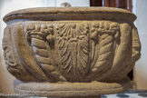 <center>Vogüé</center>Ce baptistère est une œuvre du XVIIème siècle. Il est placé à l’entrée de l’église pour signifier l’accueil par le baptême dans la communauté paroissiale.
Ce mobilier aurait été réalisé pour être une cuve baptismale célébrant la victoire de la vie sur la mort, en employant la symbolique de la Renaissance qui met en lumière les cornes d'abondance et rejette aux angles des masques grimaçants.
