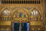<center>La Sainte-Chapelle.  </center>Le portail s'ouvre sous une arcade brisée, et deux arcades plus étroites en tiers-point la flanquent. Les tympans de ces trois arcades ont été peints par Steinheil, qui n'a pu s'appuyer sur rien d'existant, car la présence de la tribune d'orgue avait fait que ce mur fût resté vierge. Les motifs sont les trois scènes de sacrifice de l'Ancien Testament ; un Christ bénissant flanqué d'anges en prière et encadré des prophètes Isaïe et Jérémie