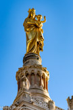 <center>La Vierge, vue de la montée des oratoires.</center>En 1866, la réalisation de la statue qui allait couronner l’édifice donna lieu à un concours. Lequesne fut retenu à l'unanimité par un jury. Plusieurs éléments furent appréciés : l'intervention personnelle de la Vierge jointe à celle de l'Enfant Jésus, le sourire de l'Enfant, les bras ouverts vers la ville, le drapé mouvementé soulignant la démarche de la Vierge.
