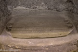 <center>Dalle Funéraire de l'abbé Isarn</center>La plaque tombale d'Isarn, datée de la fin du XIe siècle, est taillée dans le fond d'une cuve de sarcophage antique en marbre. Ce monument rappelait la mémoire de l'abbé mort un demi-siècle plus tôt. L'un des longs côtés porte encore les vestiges d'un décor bûché à l'occasion du réemploi. La dalle est constituée du réemploi d'un fond de sarcophage antique païen qui donne sa forme à l'objet. Le sommet du corps et les pieds du défunt ont été représentés dans les deux demi-cercles extrêmes tandis que le reste du corps est caché par une inscription dont la disposition, en même temps que la forme littéraire, évoquent une inspiration paléochrétienne. La qualité de la sculpture et de la graphie impliquent une réappropriation de la tradition de l'Antiquité tardive dans une période qui se situe à l'aube de la renaissance du XIIe siècle.