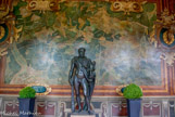 <center>Galerie des Cerfs. </center> Commode en Hercule du Vatican. Bronze fondu à Fontainebleau et réparé par J le Roux dit Picart vers 1540.