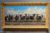 <center>Les Menons en tête d’un troupeau en Camargue</center>Émile Loubon
Aix-en-Provence, 1809 – Marseille, 1863
Huile sur toile
Présentée à Paris au Salon de 1853 avec Vue de Marseille prise des Aygalades, la peinture attire les réactions de la critique stupéfaite et ironique devant l'œuvre de Loubon. Elle fera même l’objet d'un dessin satirique par Nadar dans son album comique du Salon. La représentation du mouvement des troupeaux sur les routes poudreuses de Provence, la réduction des tons et de la couleur, la vue panoramique, sont autant d’obsessions récurrentes chez Loubon qui acquièrent ici, par les dimensions du tableau, une présence surprenante d’autant que la figure humaine disparait dans la poussière au second plan. Les boucs noirs sont des menons (du provençal « menar », mener). Il s'agit de boucs castrés qui dans les collines du Rove étaient