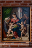 <center>La cathédrale Sainte-Cécile</center>Comme l'indique son cartouche, ce panneau fut commandé par Anne Regin. « docteur en droits, protonotaire apostolique, chantre et chanoine de cette église, grand archidiacre et chanoine d'Albi ». C'est sans doute à Albi, où il exerce entre 1529 et 1535 sous l'épiscopat de son oncle, le chancelier de France Antoine Duprat, qu'Anne Regin passe commande du tableau.
D'origine auvergnate. Anne Regin choisit d'offrir le tableau à la cathédrale de Clermont-Ferrand, pour la chapelle Sainte-Anne, qui sera le lieu de sa sépulture. Le tableau est ensuite localisé à l’hôpital de Billom (Puy- de-Dôme) d'où il disparaît dans les années 1960. Achetée par l'État auprès d'un collectionneur provençal en 2012, l'œuvre est présentée dans la cathédrale d'Albi depuis 2014.
La scène représente la sainte Famille entourée d'Anne et de Jean-Baptiste.
Le premier plan est occupé par Jésus debout dans son berceau et son cousin portant des pommes dans son vêtement, sous le regard de Marie.
Joseph et Anne occupent le second plan d'une scène prenant place dans un édifice classique ouvert sur un lointain paysage. Les références à l'art de Raphaël et à l'Antiquité montrent que son auteur, a sans doute fait le voyage en Italie, avant de s'installer en Provence.