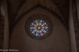 <center>Najac : Église Saint-Jean l’Évangéliste.</center>L’édifice est éclairé à l’ouest par une grande rose polylobée. Celle-ci est décorée de vitraux rehaussés de grisaille datant du XVIe siècle.