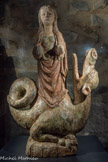 <center>Penne  </center>Statue de Sainte-Marguerite d’Antioche XVe siècle. Bois de chêne polychrome. France.
La sainte tient un pan de son vêtement dans sa main gauche et devait tenir la Bible ou une croix dans sa main droite, aujourd’hui disparue. La sculpture a conservé sa polychromie d'origine. Sculptée en ronde bosse, l'arrière de la statue laisse apparaître une chevelure de mèches épaisses.
Cette sainte légendaire est née à Antioche à la fin du IIIe siècle. Convertie au Christianisme, elle fait vœu de virginité et repousse les avances du gouverneur romain Olibrius.
La légende veut qu’elle fût avalée par un monstre et qu’elle en transperça miraculeusement le ventre pour en sortir indemne.
C’est pourquoi on la représente généralement « hissée sur le dragon ».
