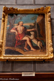 <center>L’église Saint Corneille de Puycelsi</center>Tableau et son cadre : Saint Jean-Baptiste. Saint Jean-Baptiste est assis, entourant de son bras droit un grand crucifix, et recueillant de la main gauche l'eau d'une cascade. L'agneau pose ses pattes avant sur ses genoux. 18e siècle.