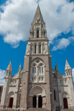<center>Basilique St Nicolas. </center>  L'église a été solennellement érigée en basilique te 28 octobre 1882.
Le grand portail et te tympan dont toutes les sculptures n'ont pas été terminées à l'exception de Saint Nicolas qui bénit le visiteur. Vallet, le sculpteur, lui a donné les traits de monseigneur Fournier