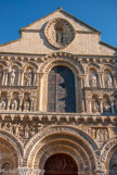 <center>Notre-Dame-la-Grande. </center> Tout en haut de l'édifice, dans une mandorle, apparaît un Christ en gloire.
Les têtes des sculptures ont été mutilées lors des guerres de religion.
Les voussures des arcades, les chapiteaux, les modillons et les corniches sont animés par le grouillement d'animaux fantastiques et le foisonnement de motifs végétaux.