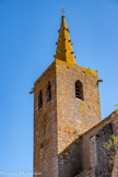 <center>Portiragnes : église Saint-Félix.</center>L'église Saint-Félix est flanquée au nord d'un haut clocher de plan carré percé à son sommet de baies campanaires ogivales à abat-sons (deux sur les faces nord et sud, une seule sur les autres faces) et de trous de boulin, et pourvu aux angles de gargouilles en forme de canon. La face nord du clocher porte deux pierres gravées du millésime « 1723 » qui marquent la réparation du clocher par un « maître maçon de la ville d'Agde ». 
Il est surmonté d'une flèche octogonale érigée également en basalte.
