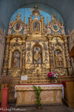 <center> Église Notre-Dame-des-Anges.</center>En haut, au centre, la statue de saint Jacques le Majeur, au centre saint Jean-Baptiste, avec à ses côtés, dans des médaillons, ses parents sainte Elisabeth et saint Zacharie. A gauche, saint Pierre (dans un médaillon en haut) et saint Joseph, et à droite, saint André (dans un médaillon), et  saint Isidore. Sous la statue de saint Jean Baptiste figure sa tête, posée sur un plateau. Hérodiade  lui crève un oeil. En bas, de gauche à droite, un saint prêtre, les attributs de St Joseph (le rabot et le compas), une religieuse, la visitation de la Vierge à Elisabeth, un saint, les attributs de st Jean-Baptiste, deux cimeterres, un saint. Dans la partie supérieure de petites statues en terre cuite et assez naïves auraient été fabriquées par les moines du couvent.