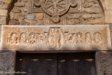 <center>Eglise Romane Saint-André</center>Le linteau, en marbre de Carrare, est du début du  XIe siècle. Le Christ bénissant, avec de part et d'autre  l'alpha et l'oméga,  est entouré de quatre saints identifiés souvent à des apôtres. et de deux chérubins. Deux anges soutiennent la mandorle. Chacun se trouvant dans un cadre constitué de colonnettes et d'un arc outrepassé.