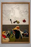 Hervé TÉLÉMAQUE
1937, Port-au-Prince (Haiti) 2022, Ivry-sur-Seine (France)
Selles comme montagne
1979
Mine graphite sur calque, papiers colorés découpés et collés, œillets métalliques
Inv.C.79.66 Achat. 1979.
En 1957, Hervé Télémaque quitte Haiti pour New York et s'inscrit à l'Art Student's League jusqu'en 1960. En 1961, il s'installe à Paris où il fréquente les surréalistes puis se rapproche des préceptes du Pop Art Dés 1962, il participe à l'aventure de la Figuration Narrative', puis s’en éloigne à partir de 1967, au profit d'un univers poétique plus hermétique, nourri par sa propre psychanalyse. Dans ses tableaux comme dans ses sculptures, se retrouvent des objets usuels dont la juxtaposition crée des énigmes à décrypter, sorte de pensée en mouvement La sexualité reste un élément clé de son travail.
Dans les années 1970, il s'adonne au dessin ainsi qu'aux collages. C'est à partir de 1974 qu'il entame la série des Selles. La selle de cheval y est souvent mise en relation avec une série d'éléments, sans lien apparent, certains étant vainement identifiables. Elle peut se transformer en paysage, comme dans Selles comme montagne, ou en habitation- Selon Télémaque, les selles font la jonction entre l'homme et l'animal surtout elles permettent de le dominer. Les selles m'intéressent parce qu'au fond c'est la même chose que les slips, les gaines que j’ai peints très longtemps, c'est une condensation du sexe. Dans le vaudou, le mot cheval est très important parce que les dieux vaudou chevauchent les possédés. Télémaque fétichise l'objet lui conférant une charge émotionnelle, sexuelle et religieuse.