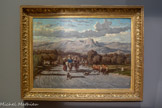 <center>Route d’Antibes à Nice</center>Emile Loubon
Aix-en-Provence, 1809 - Marseille, 1863
Huile sur toile
La route est le lieu primordial de la peinture de Loubon. Elle relie les êtres et les lieux. Bêtes et hommes la parcourent inlassablement, témoins d'une économie rurale faite de déplacements, de colportages ou de transhumances. Elle sert de scène idéale à Loubon qui a la passion du mouvement. Ses paysages sont pensés comme de vastes panoramas, quel que soit le format du tableau, dans une lumière claire que la critique décrit souvent comme blafarde. Au premier plan la forte projection des ombres et les ornières sur le sol poudreux sont autant de signatures du peintre. Elles seront reprises par les peintres du Midi comme un ultime hommage encore à la fin du siècle.