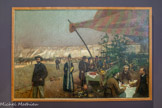 <center>Chez Brégaillon</center>David DELLEPIANE
Gènes, 1866 - Marseille, 1932.
Huile sur toile
Peintre et remarquable affichiste, Dellepiane témoigne de l’ouverture des artistes marseillais à l’évolution des courants artistiques de leur temps.
Chez Brégaiilon, célébration des bonheurs de la vie urbaine marseillaise, réunit plusieurs des grandes figures de l’école de Marseille de la fin du XIXe siècle.
Au premier plan à gauche, on reconnaît le peintre et compositeur marseillais, Ange Flégier (1846-1927). A droite, trois peintres sont attablés : Alfred Casile (1848- 1909), nous fait face, Dellepiane, l’auteur du tableau, s’est représenté de dos. Edouard Crémieux est vu de profil. Né à Marseille en 1856, il sera raflé dans la rue et déporté du camp de Drancy vers Auschwitz par le convoi n°72. Il sera assassiné avec sa femme à son arrivée dans le camp en mai 1944. Joseph Garibaldi (1863-1941) est debout devant l’étal, une canne à la main. La femme portant un cornet de coquillage est l’épouse d’Alfred Casile.
Les salons de Brégaillon, 3 quai de la Fraternité, étaient un fameux restaurant de poissons et de coquillages de Marseille. Ils tiraient leur nom du parc ostréicole de Brégaillon à la Seyne-sur-mer, le plus important de la région.