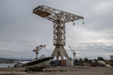 <center>Les Chantiers Navals de La Ciotat. </center>Aujourd’hui, le chantier naval de La Ciotat accueille 41 entreprises privées, pour 600 employés et plus du double de sous-traitants. Le site est passé de 90 bateaux en 2004 à 500 escales en 2014, dont 300 mises à sec. Il génère un chiffre d’affaires de 70 millions d’euros et se positionne comme le premier chantier naval d’Europe et un acteur mondial de premier plan.<br> Emplacement de la cale n°2. Reconstruite en 1952, elle faisait 172m de long sur 31m de large, elle permettait la construction d’unités de 32.000 tonnes et comprenait 3 grues de 3 à 7 tonnes, une grue de 90 tonnes et celle de 120 tonnes de la cale n°1 (sur la photo). A gauche, la grue qui s'est pliée et qu'il a donc fallu renforcer.