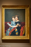 <center></center>JACQUES-LOUIS DAVID, 1748 – 1825.
PORTRAIT DE CHARLOTTE ET ZENAÏDE BONAPARTE, 1822.
Huile sur tôle. Achat 1872 - Inv, 956.32.1.<br>
Élève de Joseph Marie Vien, il obtient le Grand Prix de l’Académie en 1774. Parti em Italie, il revient enm France en 1781. Ses idées politiques en font le peintre de la Révolution, mais i1 se rallie à Bonaparte et devient peintre officiel de l’Empire. A la Restauration, il doit s’exiler à Bruxelles où il continue à peindre jusqu’à sa mort.
La scène représentée dans ce tableau montre les deux jeunes filles de Joseph Bonaparte réfugiée à Bruxelles en 1820, recevant une lettre de leur père, qui séjourne à Philadelphie aux États-Unis..
On retrouve dans ce double portrait la manière habituelle de David. Fond uni moucheté, personnages de trois-quarts dont la silhouette est arrêtée au-dessous du genou. La mise en page simple et familière fait ressortir les deux visages dans la partie supérieure du tableau tandis que la partie inferieure est une description magistrale des toilettes : velours noir, taffetas gris, écharpes bariolées, sur le fond rouge grenat du canapé.