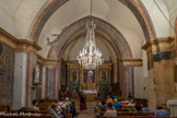 <center>Montbrun-les-Bains.</center> Il existait déjà une église à Montbrun au XIIe siècle. Elle était liée à l’abbaye Saint-André de Villeneuve (les Avignon), dont le rayonnement était important dans les Baronnies. Cette puissante abbaye bénédictine possédait aussi les églises d’Aulan, de Barret et de Reilhanette. L’église de Montbrun est de nouveau mentionnée en 1308. La paix religieuse rétablie pour un temps grâce à l’Edit de Nantes (1598), l’édifice qui devait être en très mauvais état fut progressivement transformé, dans l’esprit missionnaire de la contre-réforme et le style baroque qui s’imposait alors.
La paroisse qui portait le nom de St Elias s’appela désormais N.D. de tous les Saints (en 1641). Les travaux d’agrandissement et de transformation vont durer presque deux siècles ; ils vont faire de cette modeste église de village un grand édifice baroque : à l’intérieur, réfection de la nef et mise en place d’un grand retable, à l’extérieur, érection d'un clocher et d’un grand portail classique. Les travaux de restauration de 1978 ont rendu à l’église son patrimoine en dégageant d’abord les fresques et décorations antérieures aux guerres de Religions, en restituant ensuite son authenticité au décor baroque malmené par les transformations ultérieures.